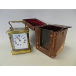 A gilt brass carriage timepiece with white enamel dial, Roman numerals,