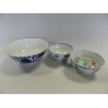 Three Chinese blue and white bowls decorated with lotus flowers,