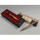 A rolled gold retracting pencil together with a Rite Point Cunard White Star Line Queen Elizabeth