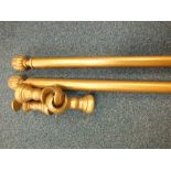 Eleven gilded curtain poles with pineapple terminals