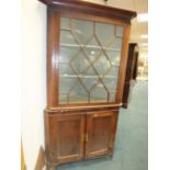 A George III oak and mahogany floor standing straight fronted full height corner cabinet with