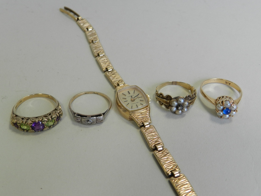 A lady's 9ct gold Tissot wristwatch together with a 9ct gold five stone amethyst and peridot ring,