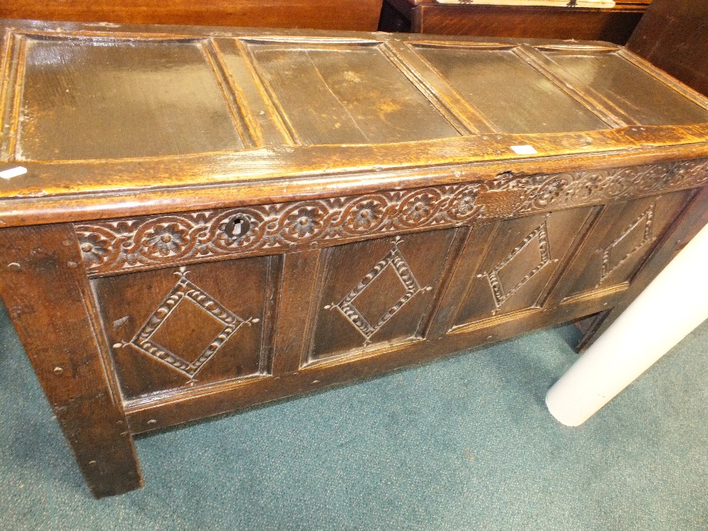 A 17th century joined oak chest with four panel top,