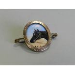 An oval enamel plaque depicting a horse named 'kaiser' within yellow metal mount,