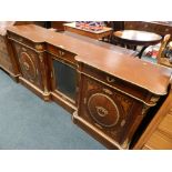 A Louis XVI style inverted breakfront side cabinet with glazed central door flanked by two cupboard