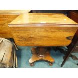 An early Victorian rosewood flap top table with single end frieze drawer containing three small