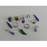 A pair of purple stone set ear pendants together with a jade pendant in the form of a claw,