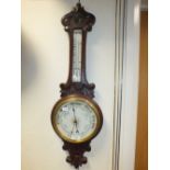 An oak cased aneroid banjo barometer