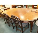 An early 20th century mahogany Hepplewhite style extending dining table along with a set of six