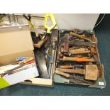 Various boxes containing a selection of tools including hammers, saws, screw drivers, mallets,