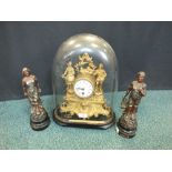 A French gilt metal style figural mantel clock with glass dome together with a pair of spelter