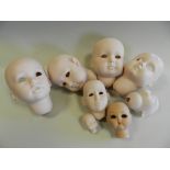 A group of German bisque porcelain doll heads, (undecorated) including 'Helga',