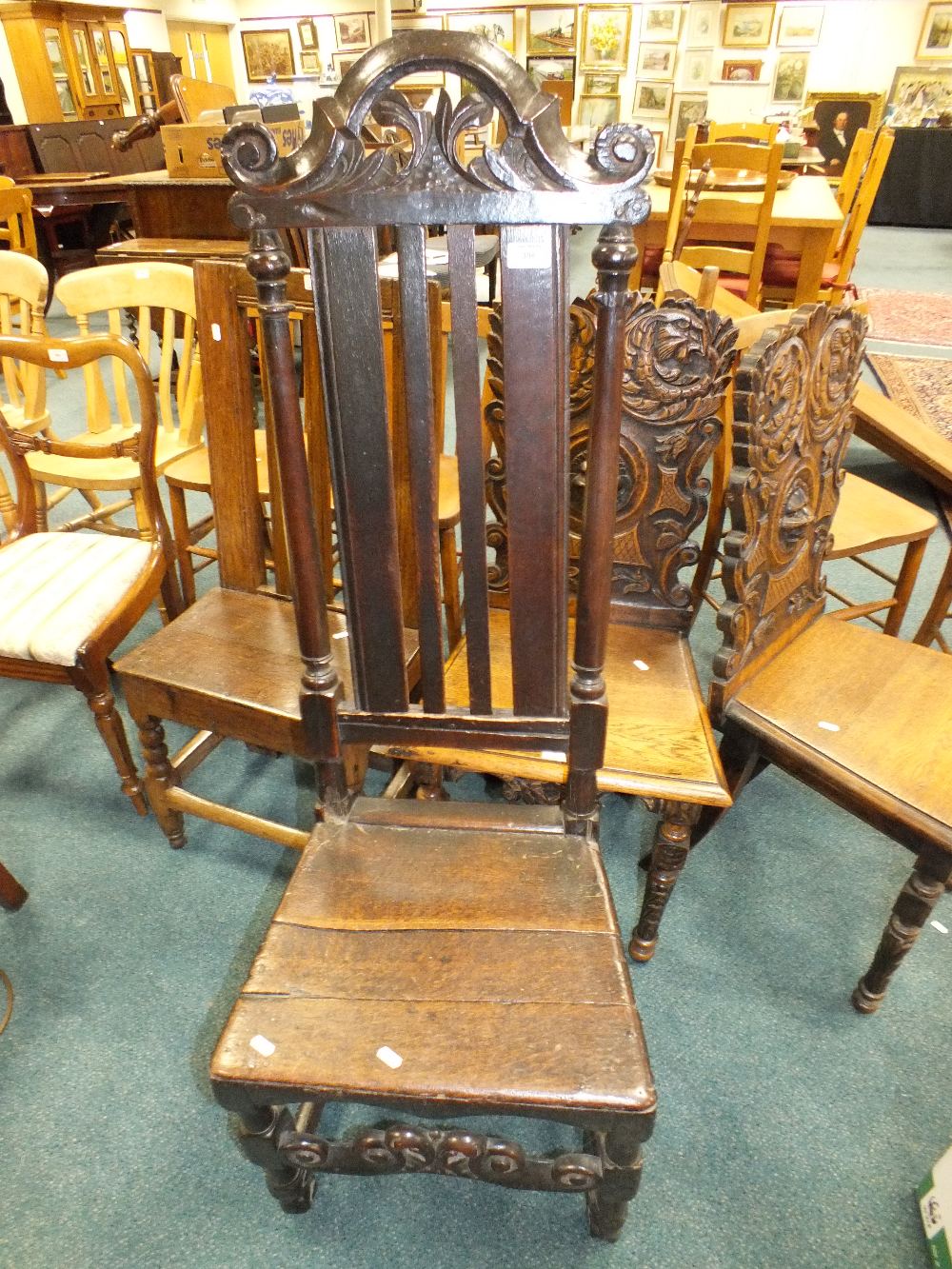 An early 18th century oak panel seat chair with shaped top rail and front rail