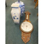 An early 20th century oak backed aneroid barometer along with a modern Chinese lidded storage jar