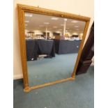 A late Victorian gilt framed overmantel mirror with bead and floral border, 115cm wide,