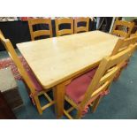 A modern oak rectangular refectory type dining table along with a set of eight ladder back dining