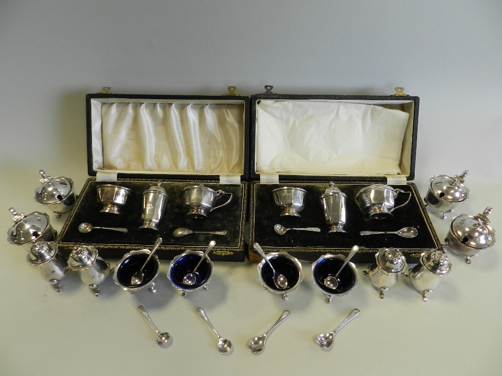 A collection of silver cruets comprising four mustards,