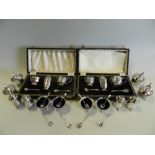 A collection of silver cruets comprising four mustards,