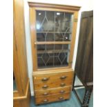 A pine cabinet on chest with ribbed glazed door above four short drawers, 69cm wide,