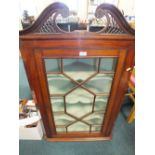 A 19th century mahogany Chippendale style wall hanging straight fronted corner cabinet with swan