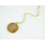 A 9ct gold circular locket, commemorating the Investiture of the Prince of Wales,