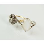 A cabochon moonstone set ring, the white metal shank stamped '18ct', size O 1/2,