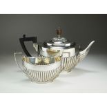 A Victorian silver teapot and sugar bowl, EH, London 1891, each of oval reeded form,