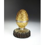 A silver and gilt surprise clock-work musical Easter egg, Christopher Nigel Lawrence, London 1982,