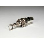 A novelty silver whistle in the form of a dogs head, Birmingham, stamped '925', 4cm long,