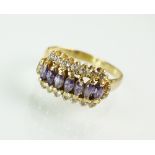 An amethyst and white stone cluster ring, the yellow metal shank stamped '18ct', ring size Q,