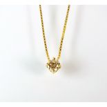 A single brilliant cut diamond pendant, within claw setting, suspended from yellow metal chain,