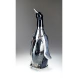 A novelty glass and chromium plated musical spirit decanter in the form of a penguin,