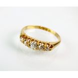 An 18ct gold five stone graduated diamond ring, the old cut diamonds claw set to yellow gold shank,