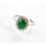 An emerald and diamond oval cluster ring,