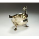 A George III silver sauce boat, William Skeen, London 1767, of typical form with cusped rim,