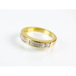 An 18ct gold seven stone Princess cut diamond ring,