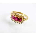 An 18ct gold ruby and diamond cluster ring,