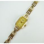 A Lady's 9ct gold Rotary quartz bracelet watch, the octagonal champagne dial with batons,