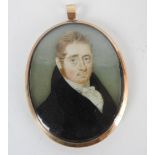 British school, Early 19th century, Portrait miniature of a young man, wearing a black coat,