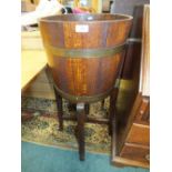 An oak jardiniere stand of coopered barrel form with retailers label for R A Lister and Co.