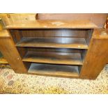 A figured walnut veneered break top floor standing bookcase with three open shelves flanked by tall