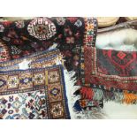 Three various coloured wool small Persian rugs