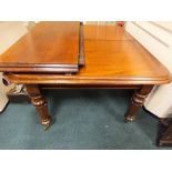 A William IV mahogany pull-out extending dining table with bevelled rectangular top and three extra