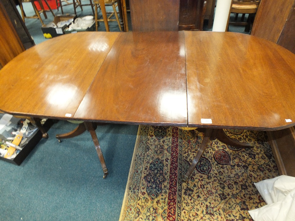 A George III style mahogany D-end twin pillar dining table with extra leaf, 168cm long, 84cm wide,