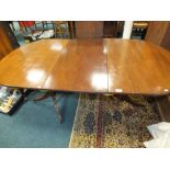 A George III style mahogany D-end twin pillar dining table with extra leaf, 168cm long, 84cm wide,