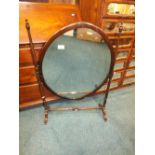 A large mahogany oval swing toilet mirror 60cm wide,