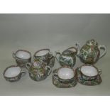 A Chinese Canton enamel tea service comprising tea cups, sucrier and cover, saucers, side plates,