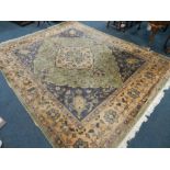 A large Chinese washed coloured wool rug with green lozenge medallion within blue and yellow and