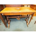 A Victorian figured walnut card table the rectangular fold over swivel top with a baize lined