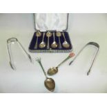 Two silver gilt and enamelled spoons with floral terminals together with two pairs of silver sugar